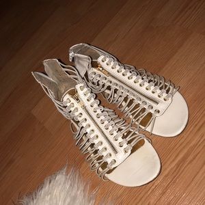 Women’s white and gold sandals.